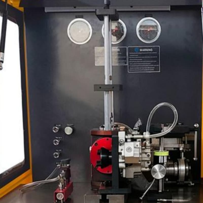 Detail view of the inner test chamber of the CR1017-PLUS demonstrating the high-pressure rail clamps, sensors, and mechanical mounting fixtures during operation.