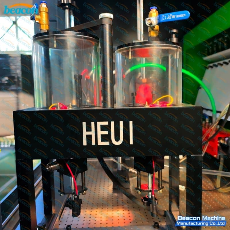 Dual graduated glass beaker testing chamber designed for HEUI hydraulic electronic unit injector validation. Dual graduated glass beaker testing chamber designed for HEUI hydraulic electronic unit injector validation.